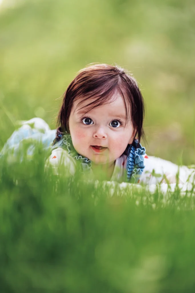 bébé sur le ventre dans un champ